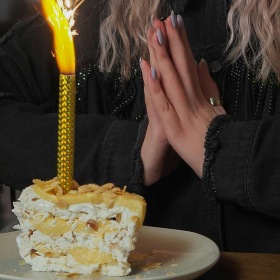 Bustling community with plenty of dining choices a woman blowing a candle out on a cake
