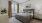 a bedroom with a bed and lamps