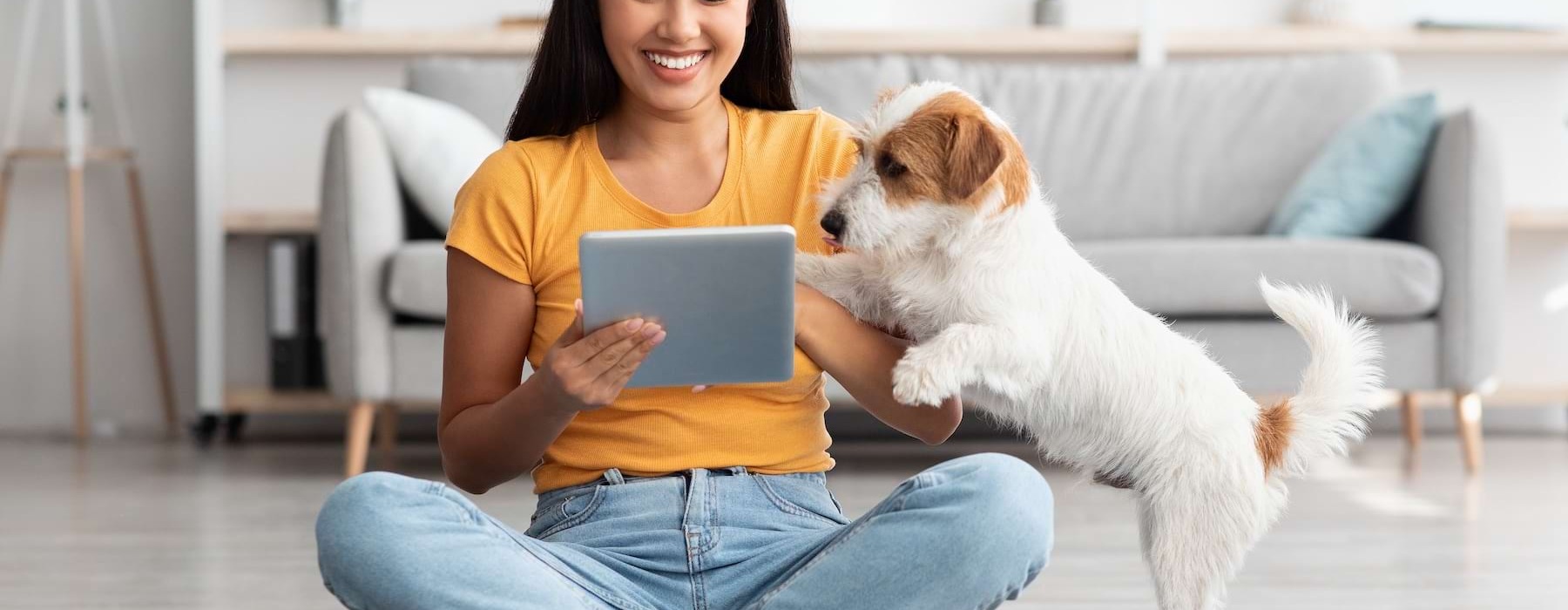 a woman on a computer with her dog