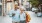 a man and woman holding shopping bags while walking